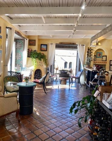 Sunlit gallery space with plants and artwork