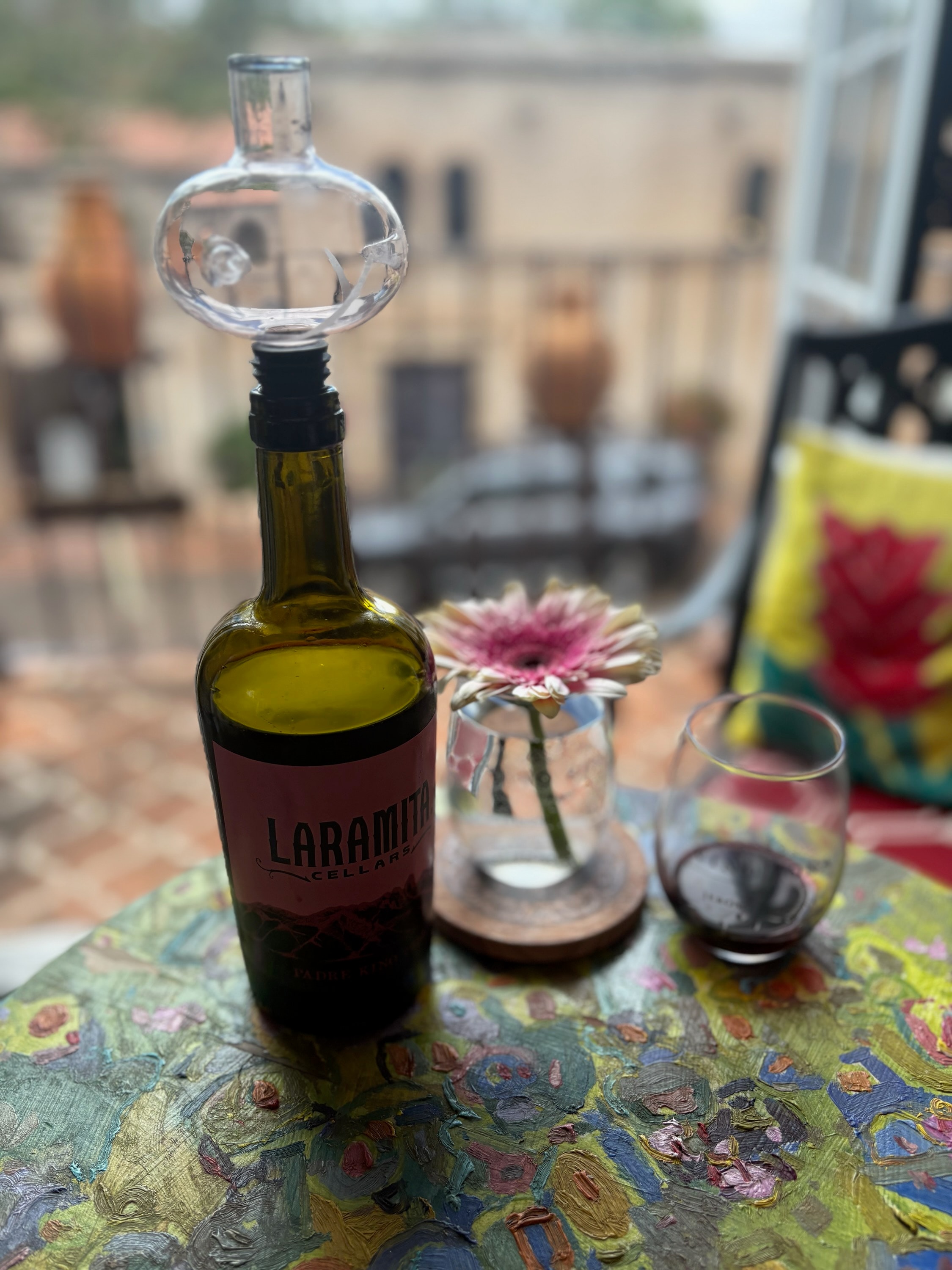 Laramita Cellars wine on painted table with flowers
