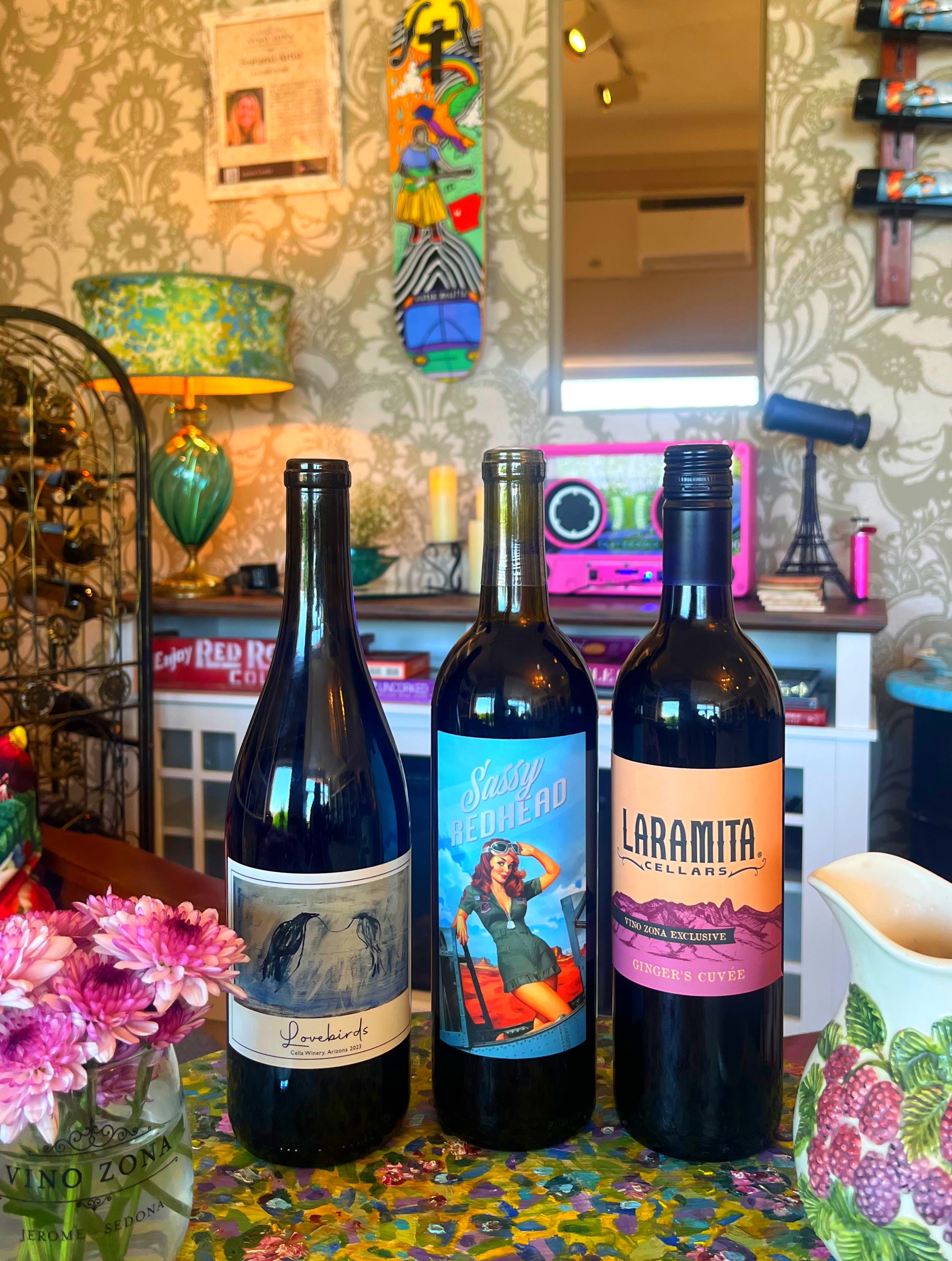 Three Vino Zona wine bottles on colorful surface