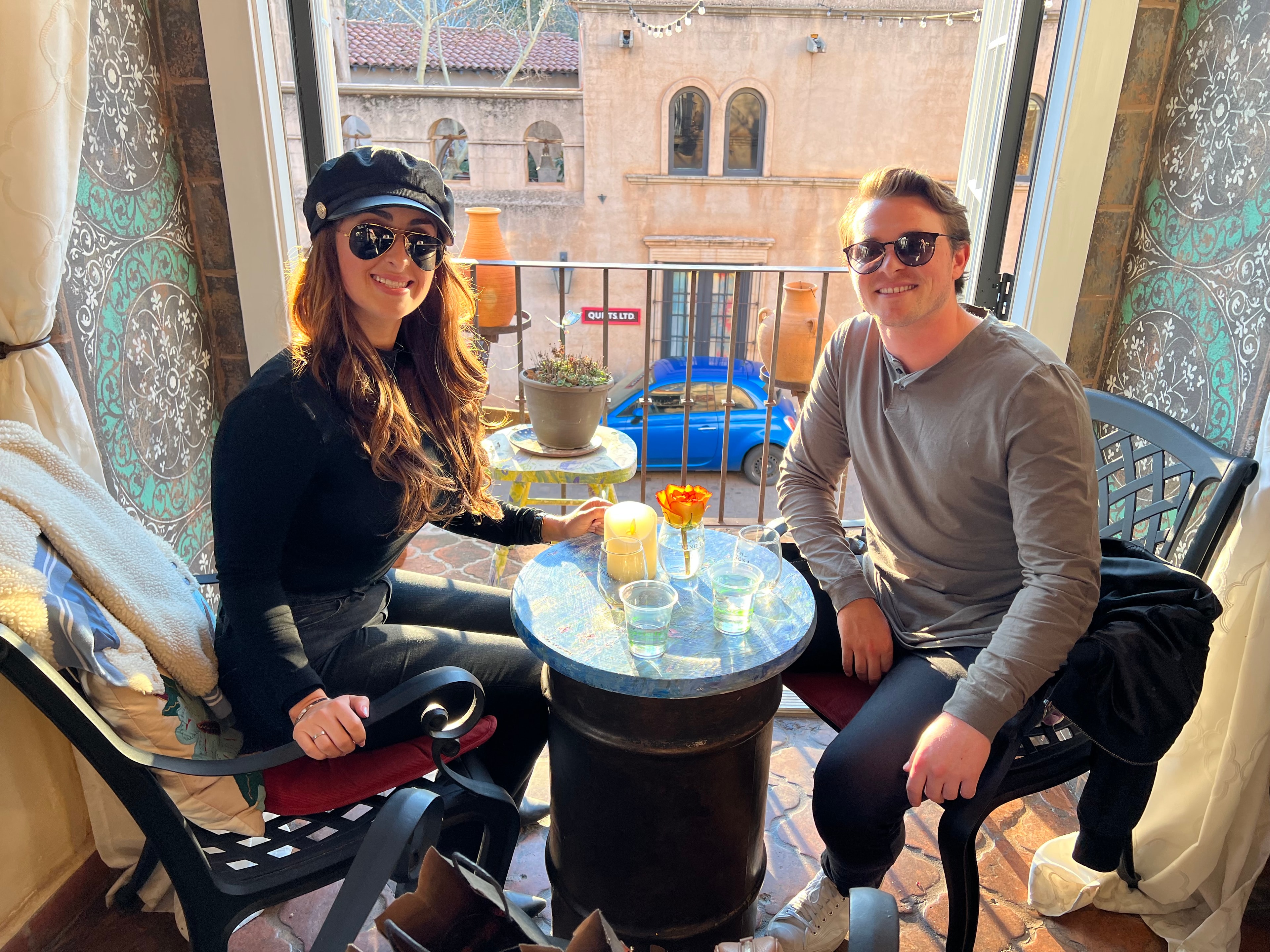 Couple enjoying wine on the balcony at Vino Zona