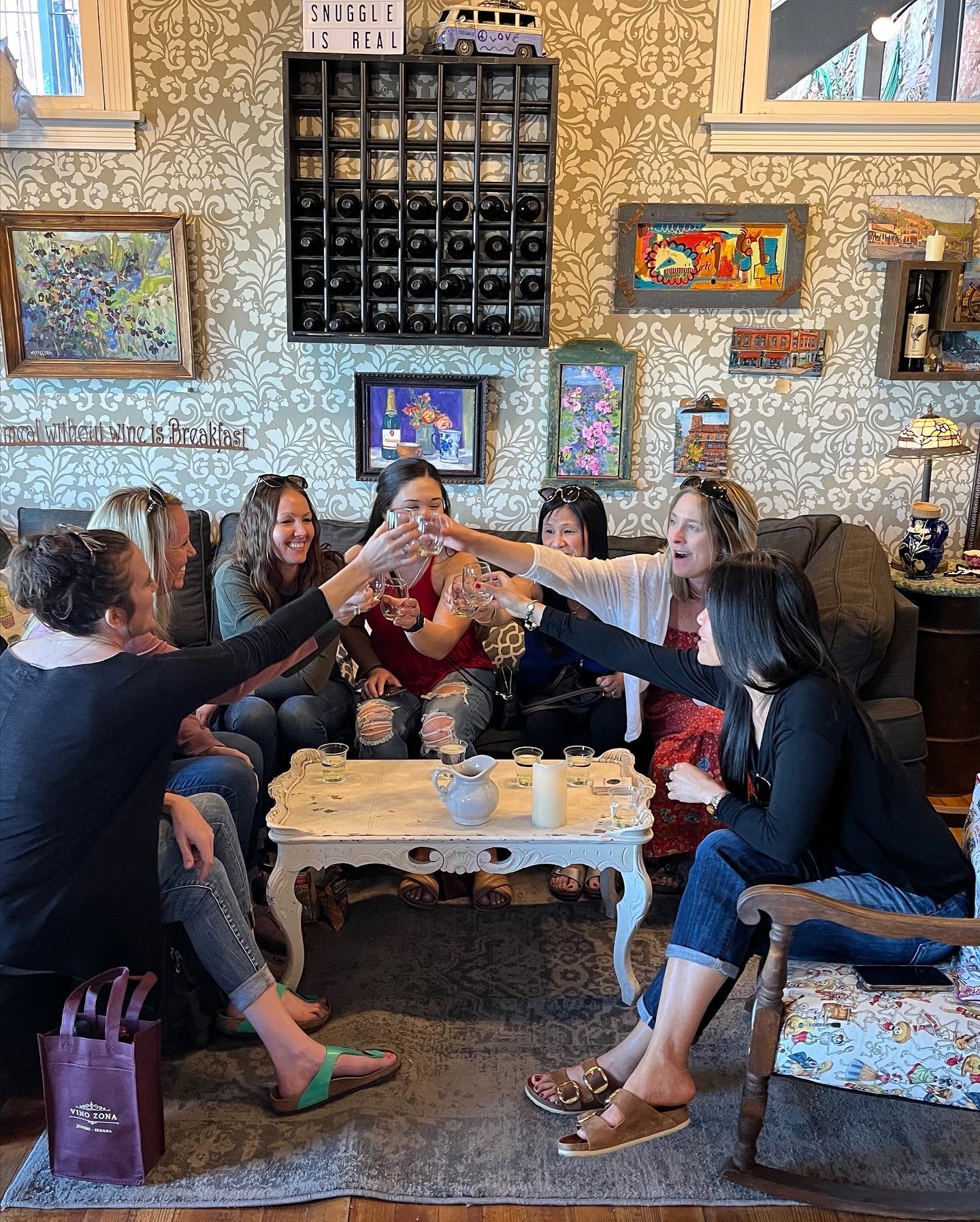 Friends toasting wine at Vino Zona tasting room